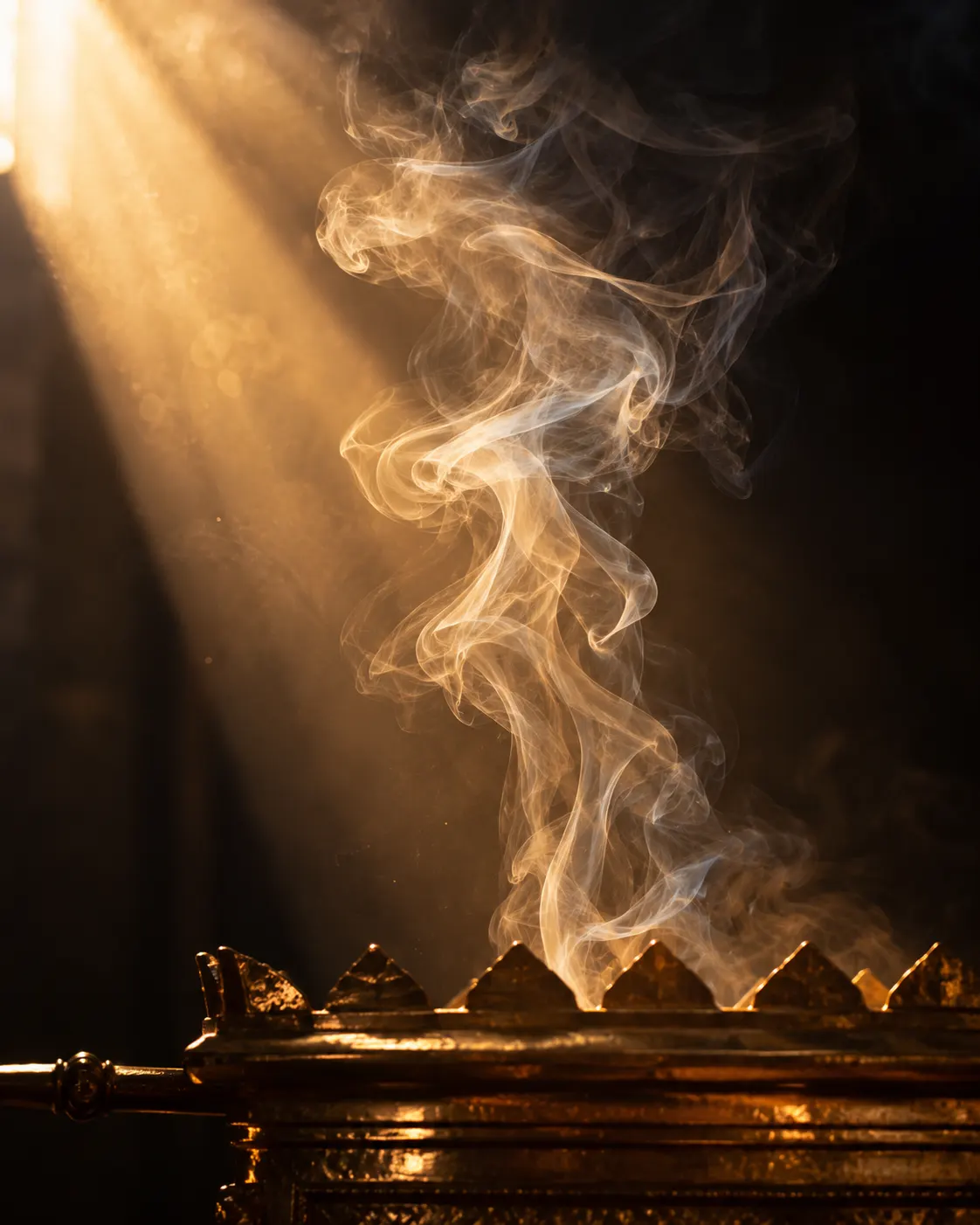 Thin ribbons of incense smoke rising through a shaft of golden light in darkness.